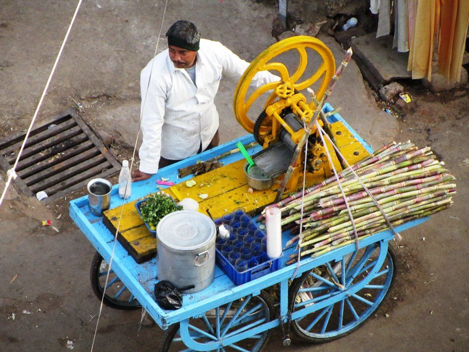Sugar cane man waits for customers in Pushkar