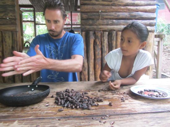 Jared and Evelyn shell the cacao beans